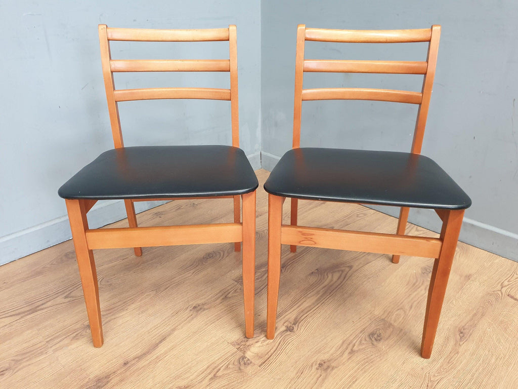 Two Mid Century Danish Influenced Teak Style Black Vinyl Pad Dining Chairs