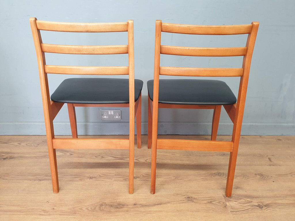 Two Mid Century Danish Influenced Teak Style Black Vinyl Pad Dining Chairs