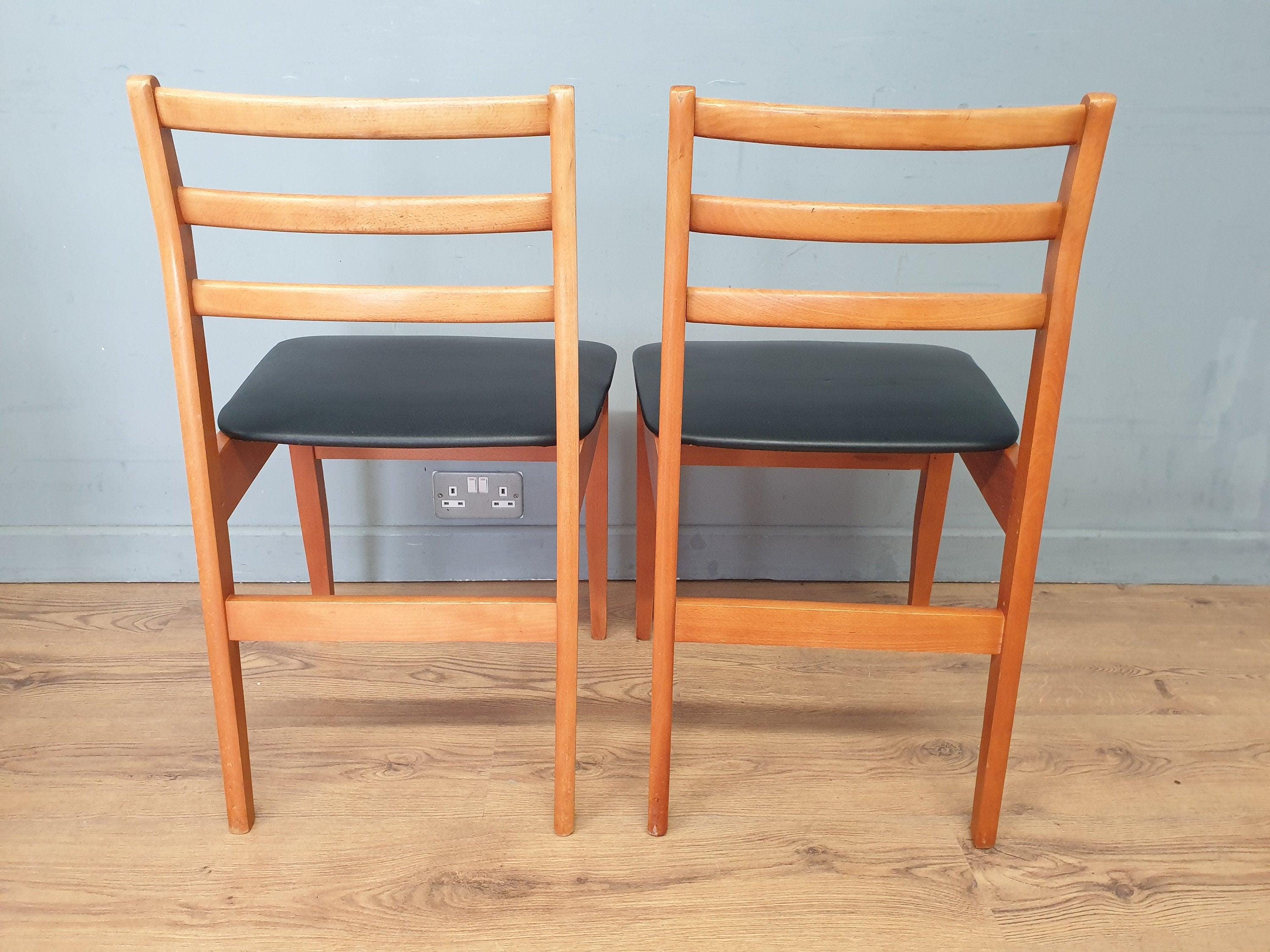Two Mid Century Danish Influenced Teak Style Black Vinyl Pad Dining Chairs