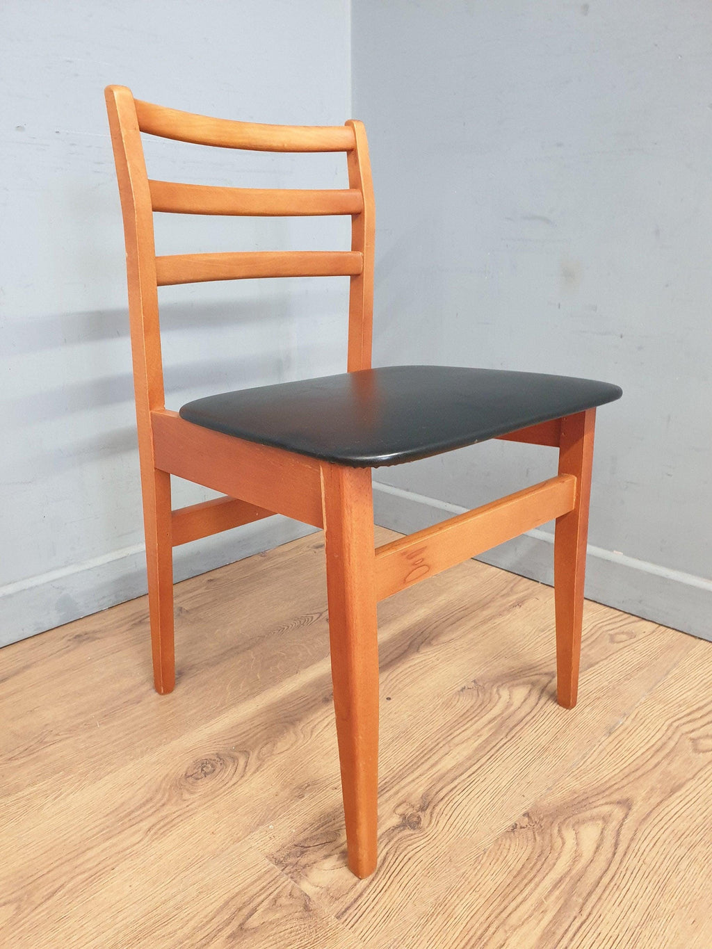 Two Mid Century Danish Influenced Teak Style Black Vinyl Pad Dining Chairs