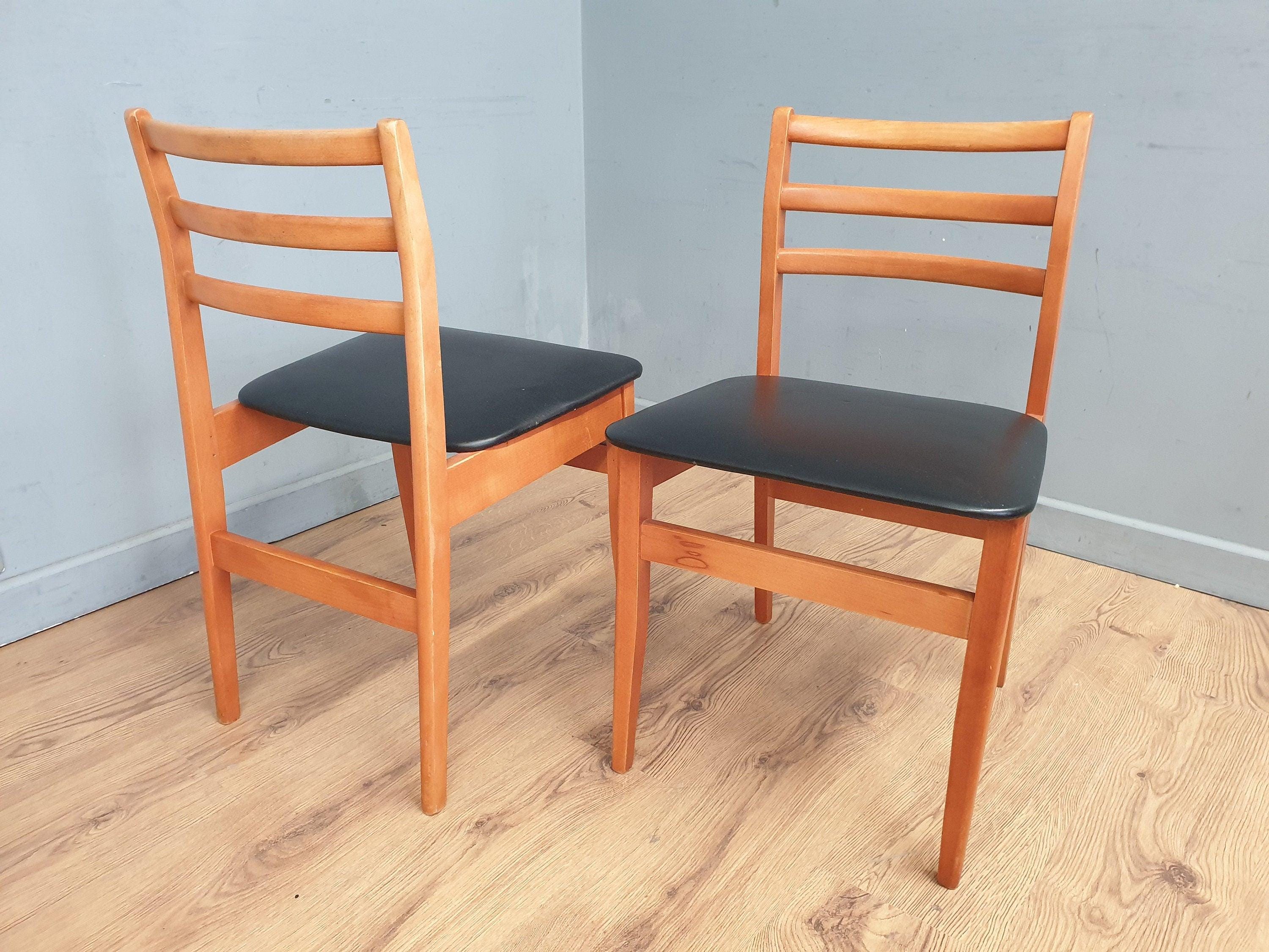 Two Mid Century Danish Influenced Teak Style Black Vinyl Pad Dining Chairs